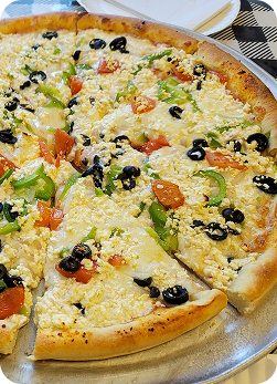 image of a pizza with veggies